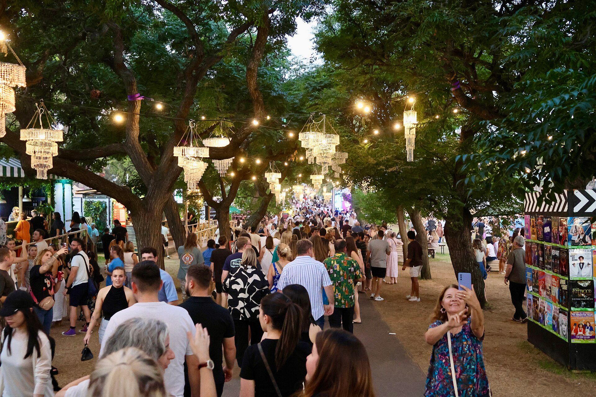 Crowds beneath lanterns at the Gluttony hub during Adelaide Fringe 2025