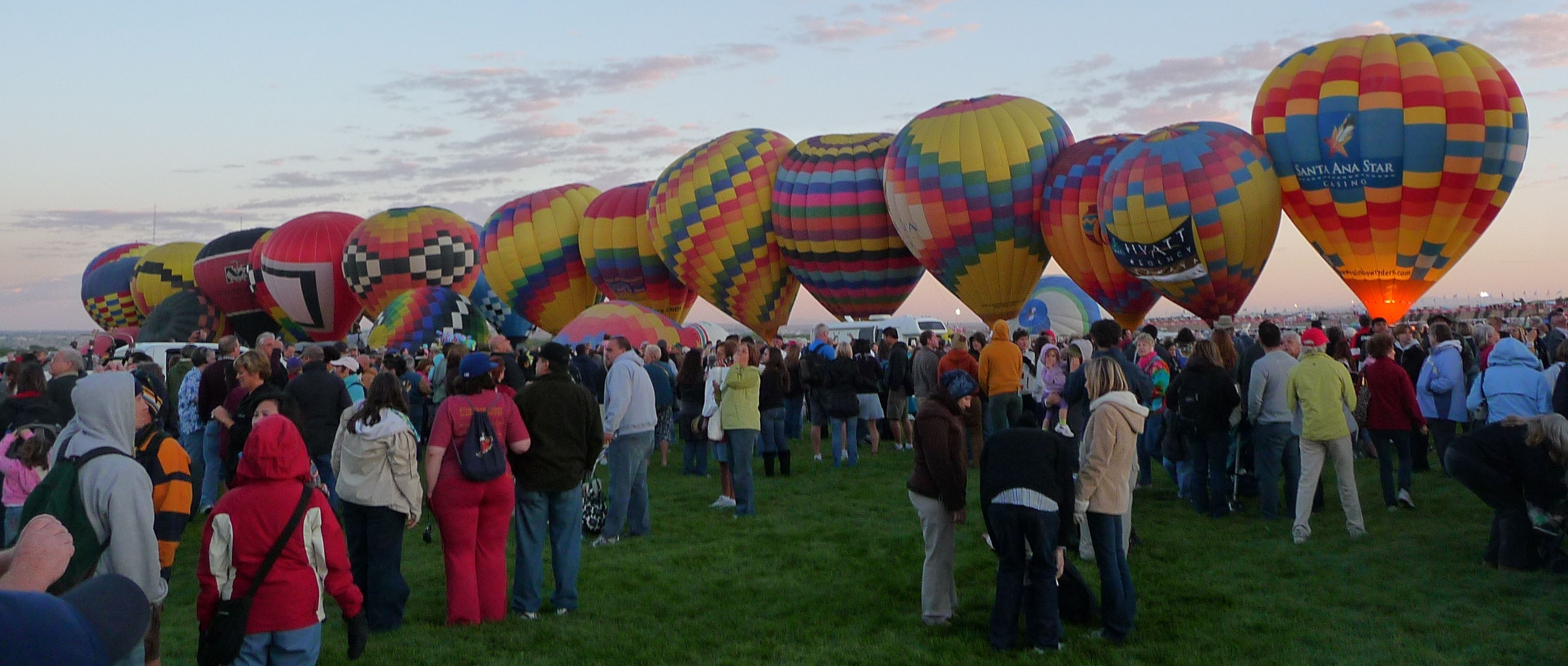 Hot air balloons rising at dawn over the launch field at the 2011 Albuquerque International Balloon Fiesta; historical edition, not the 2027 event.