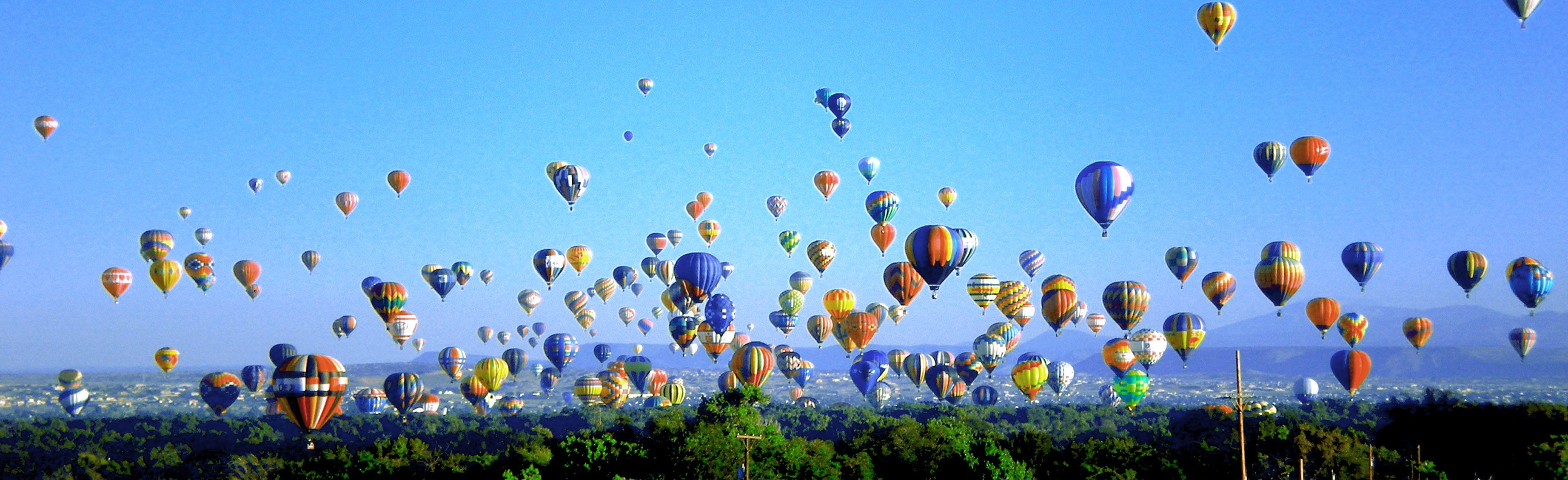 Colorful balloon envelopes filling the sky during mass ascension at the 2007 Albuquerque International Balloon Fiesta; historical edition, not the 2027 event.