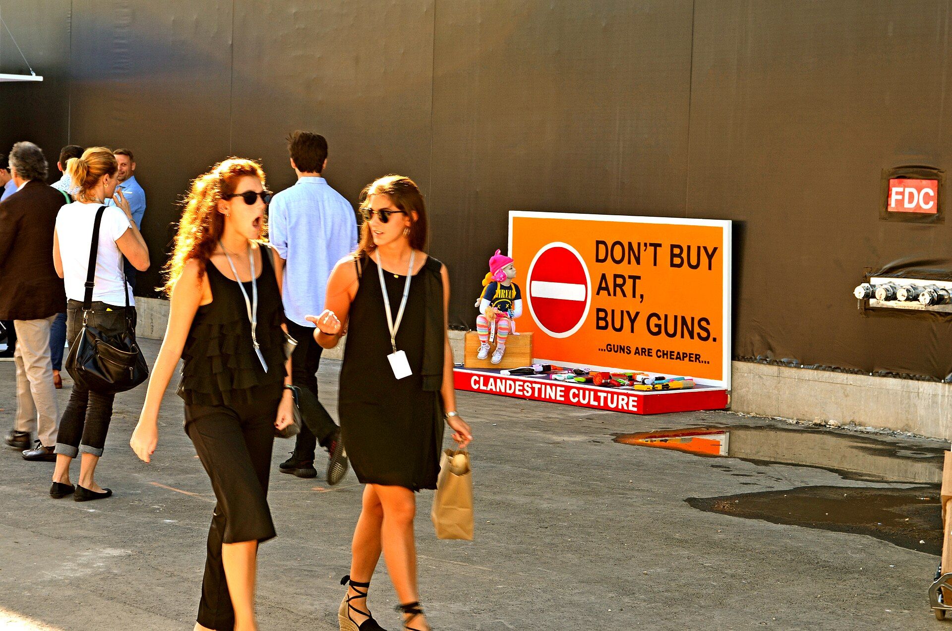 Visitors passing the Poison Kiss installation during Art Basel Miami Beach in 2017