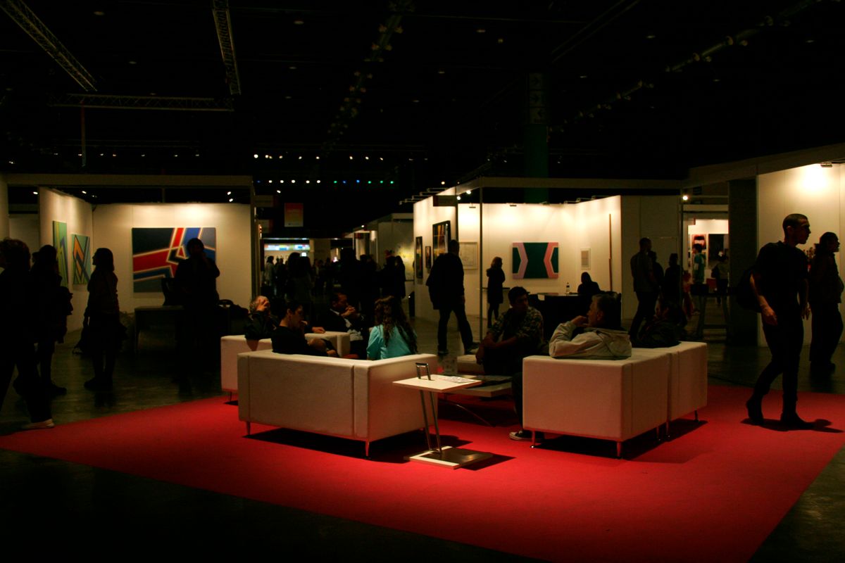 Visitors moving through an arteba contemporary-art fair floor