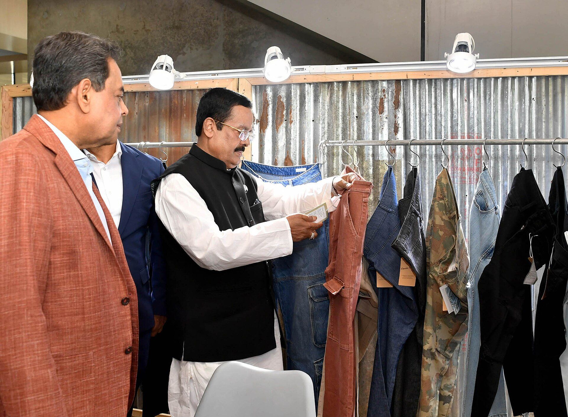 A visitor examines denim garments at Bangladesh Denim Expo in 2024