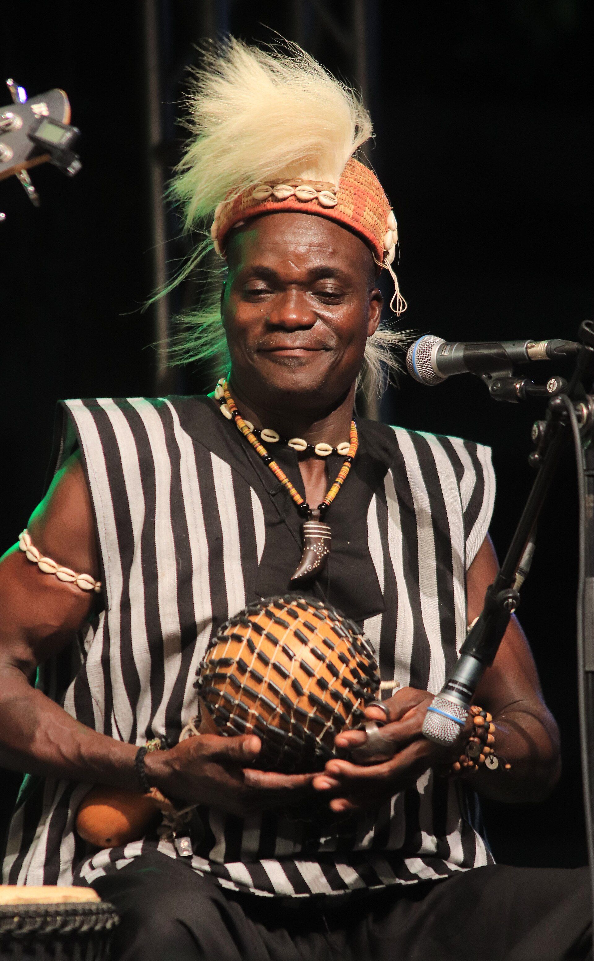 Musician performing with a traditional Beninese instrument