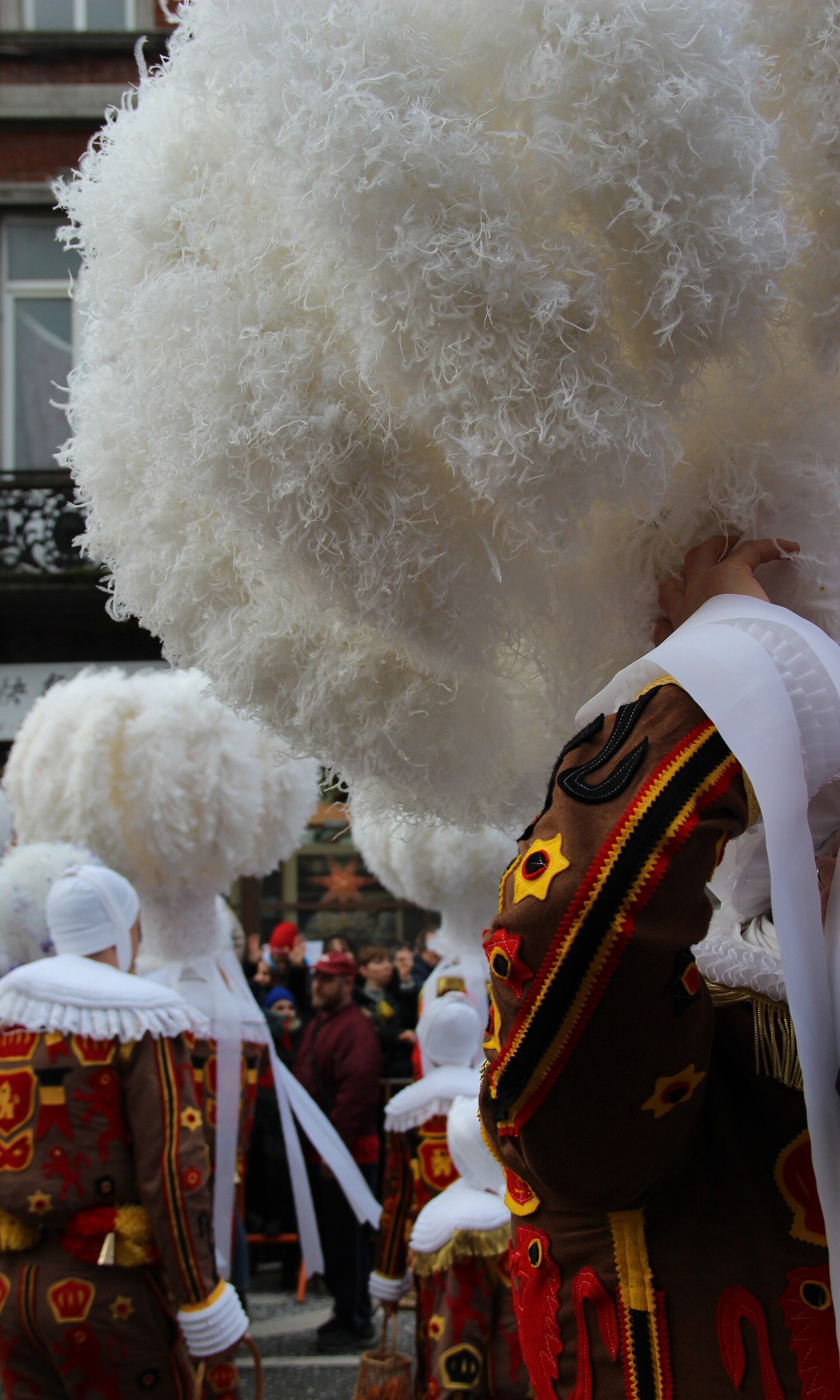 Costumed participants moving through Binche during the 2024 carnival