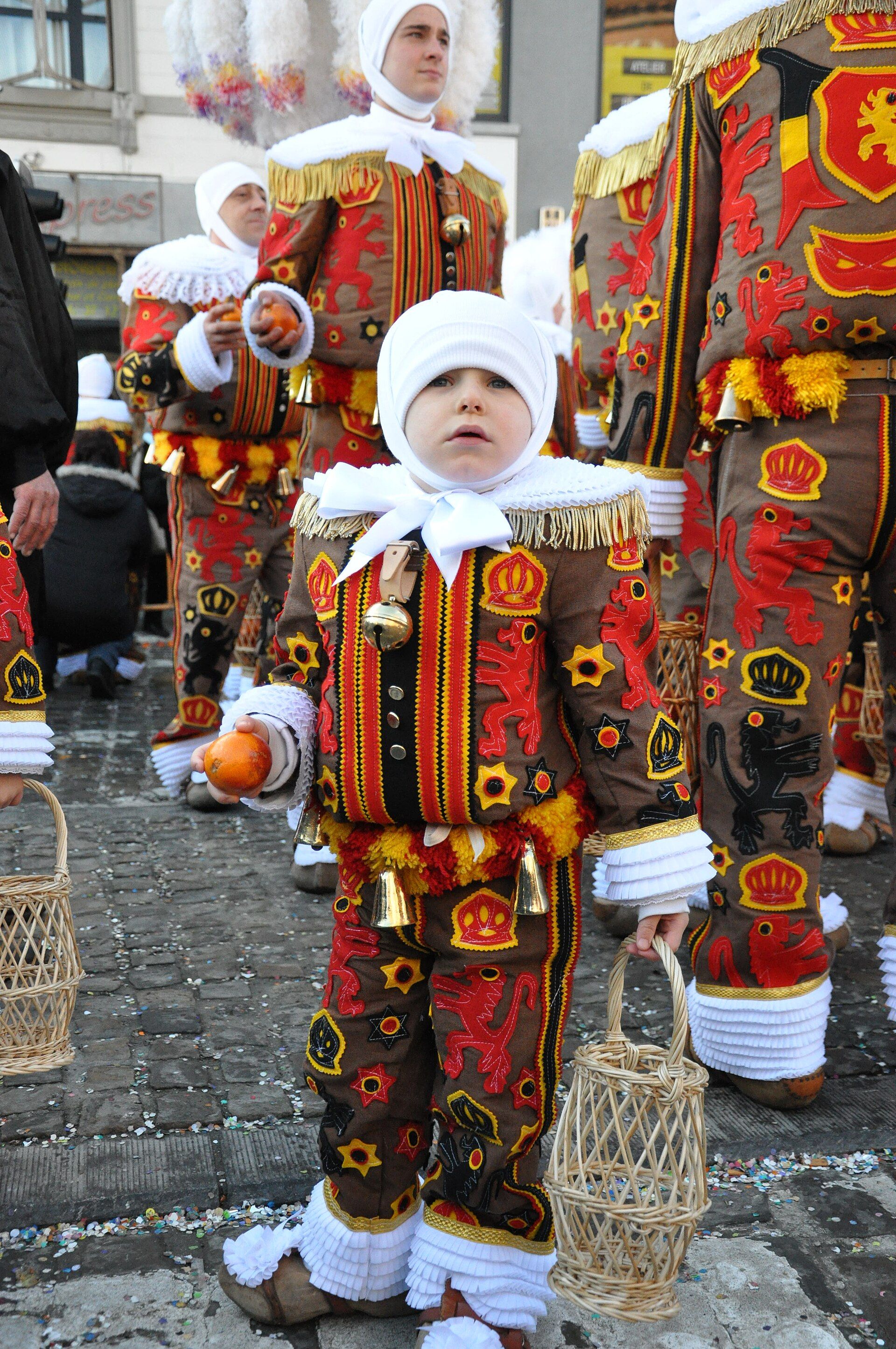 A Gille in the traditional red, yellow and black Carnival of Binche costume