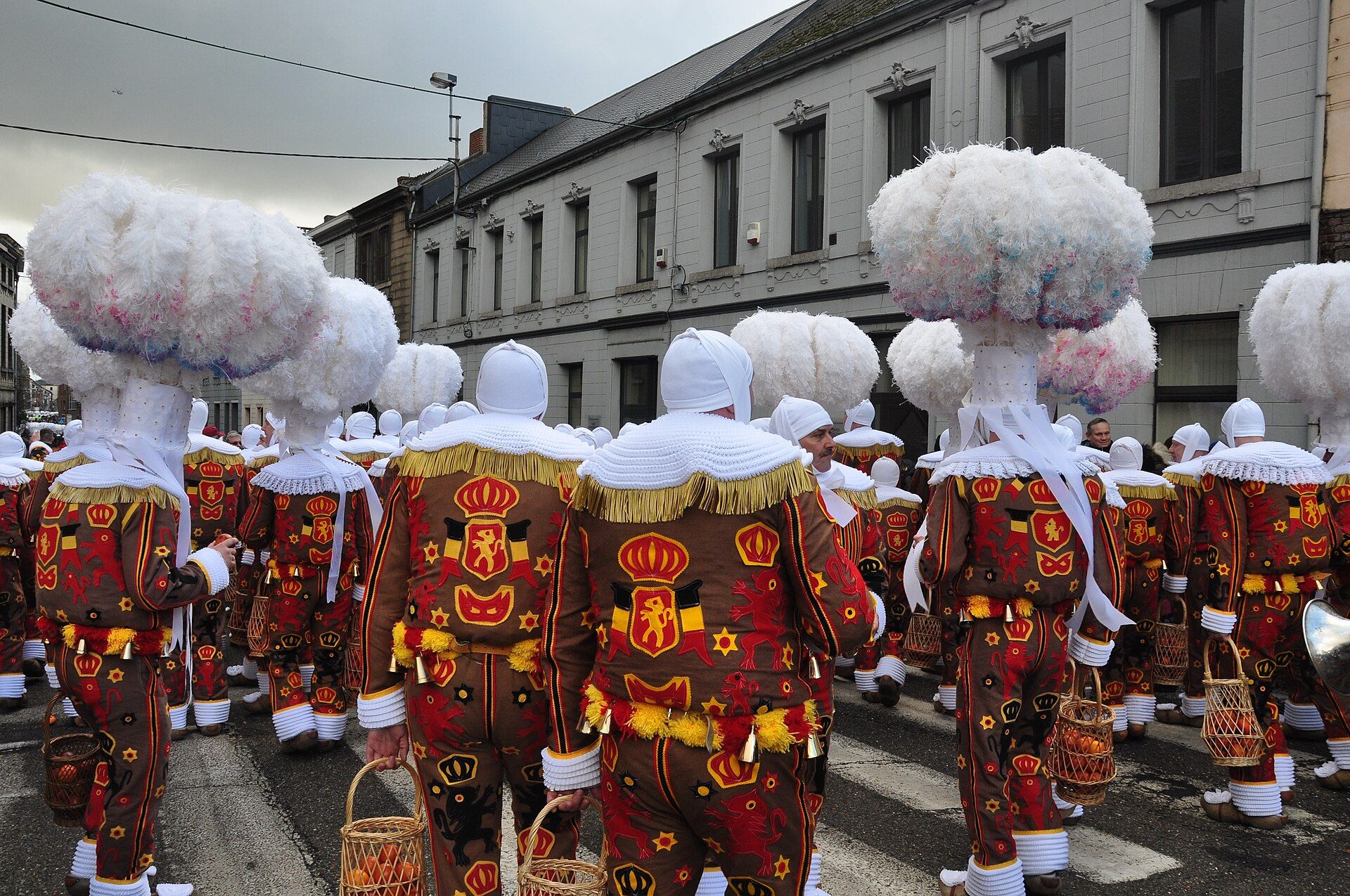 A group of Gilles in feathered hats during the Carnival of Binche