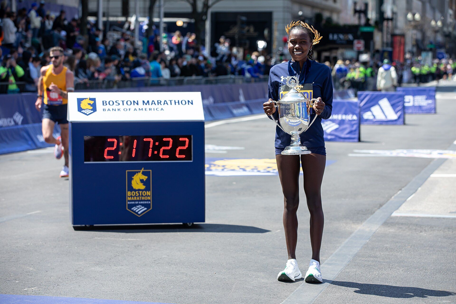 Sharon Lokedi holding the winner’s trophy at the 2025 Boston Marathon