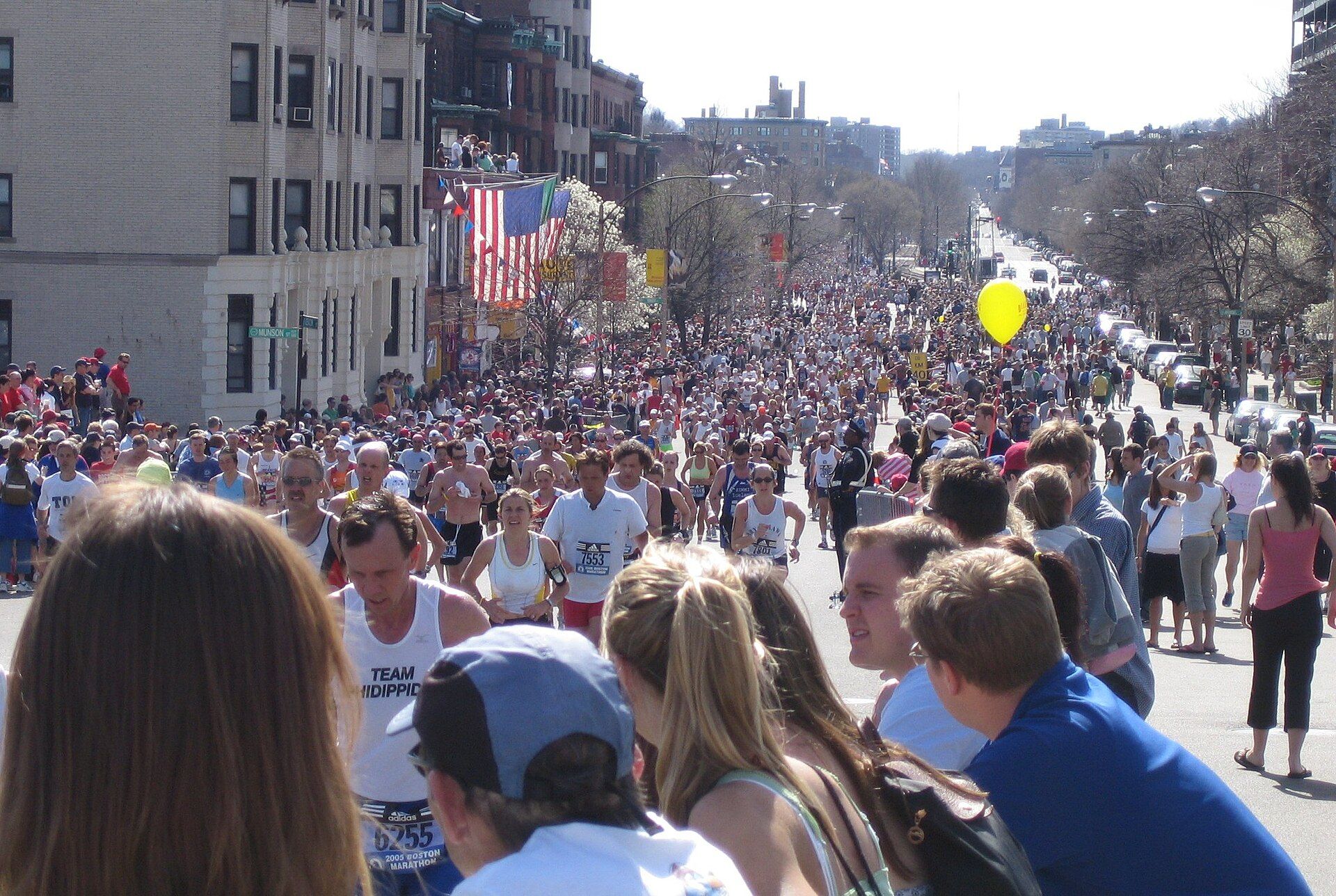 Runners and spectators filling Beacon Street near mile 25