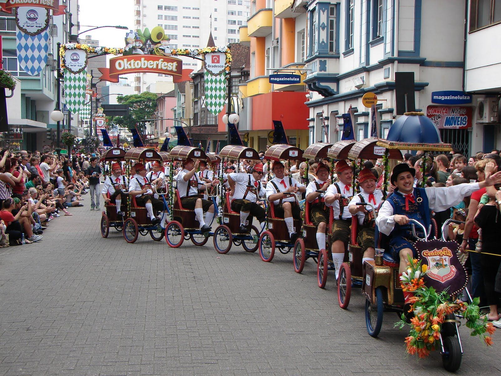 Oktoberfest Blumenau parade moving through a crowded city street