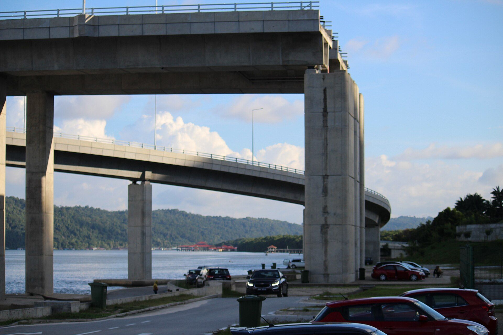 Road approach beneath the tall concrete structure of the SHOAS Bridge