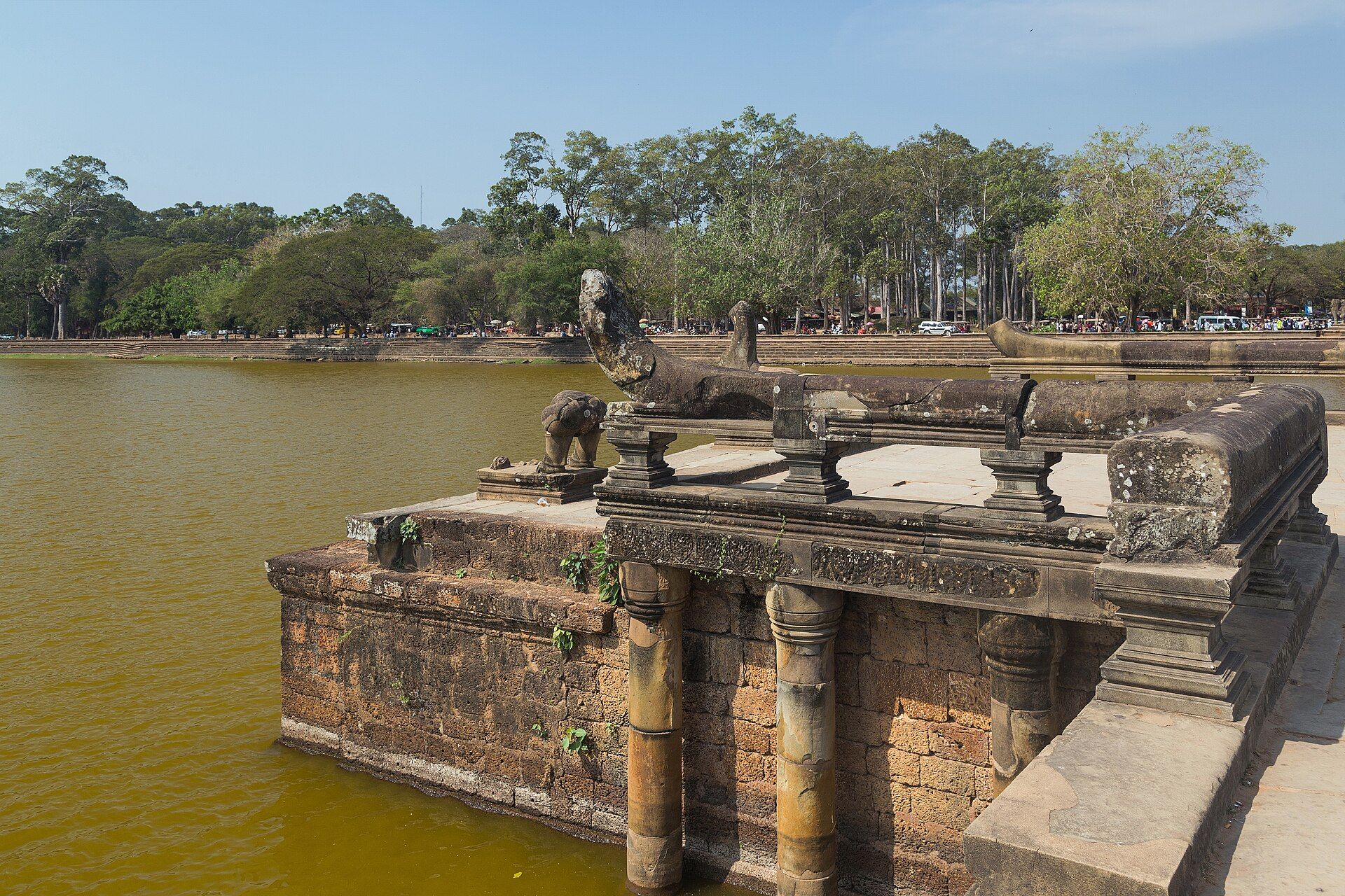 Visitors crossing the causeway toward Angkor Wat