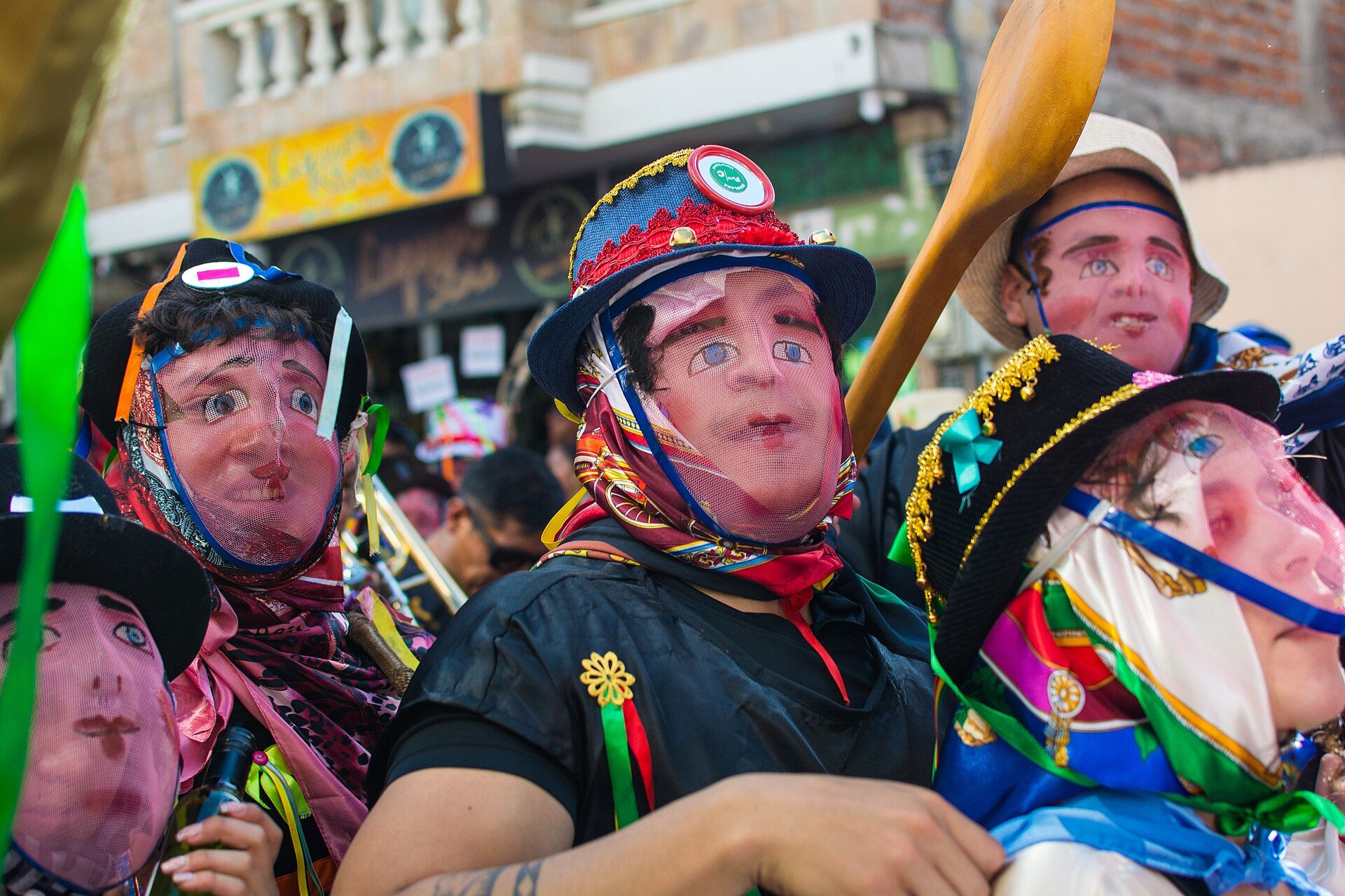 Guarichas wearing wire masks during the Diablada Pillareña