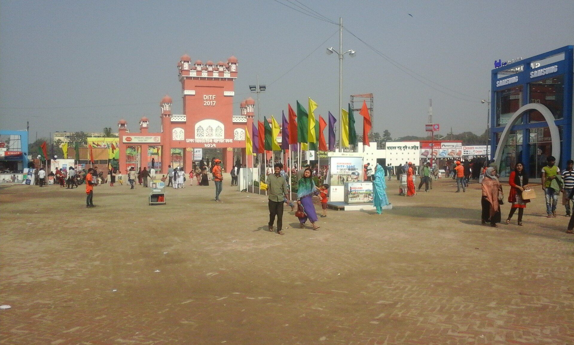 Visitors walking among pavilions at a prior Dhaka International Trade Fair