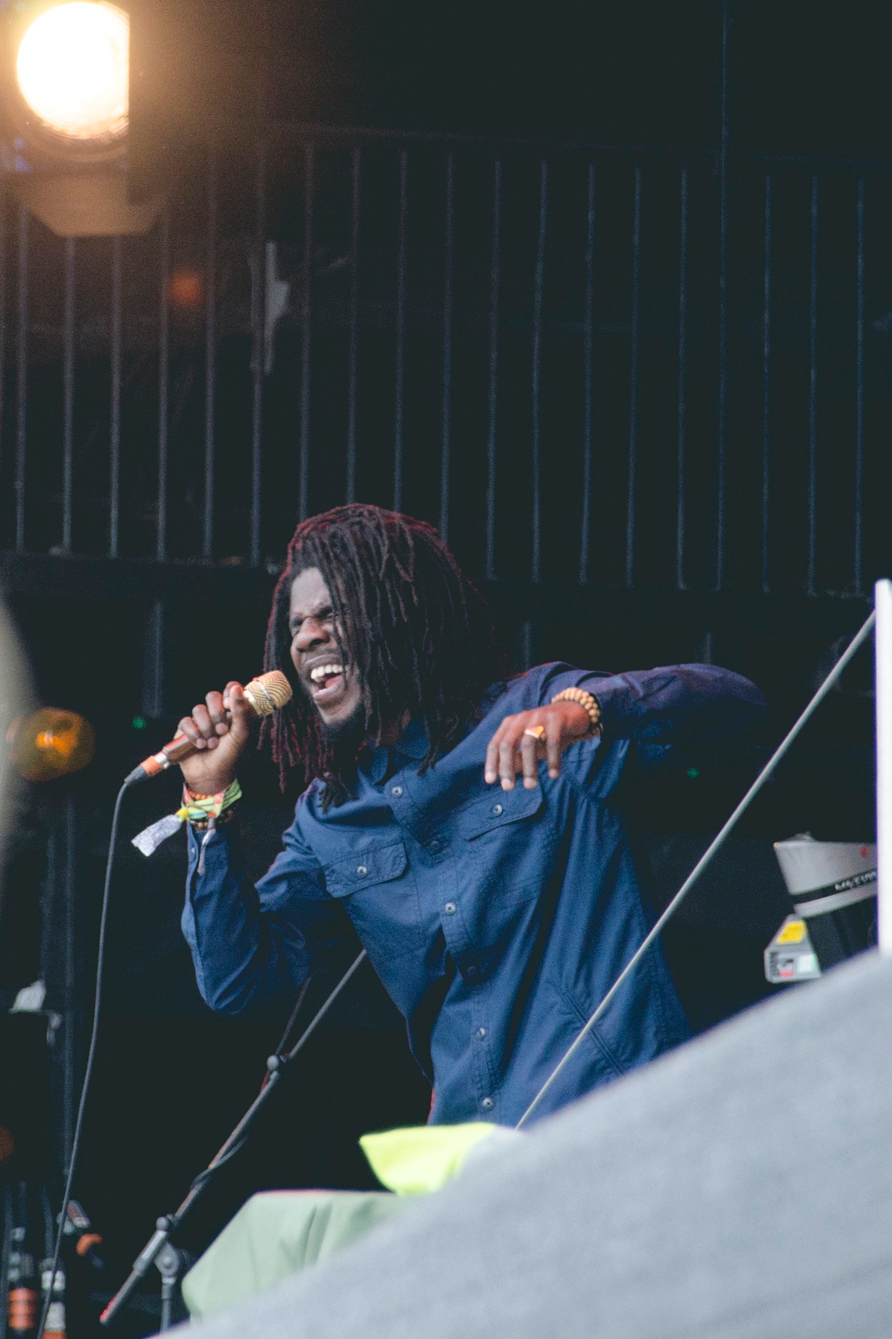 Chronixx performing on the Pyramid Stage at Glastonbury Festival 2015, shown as historical context.