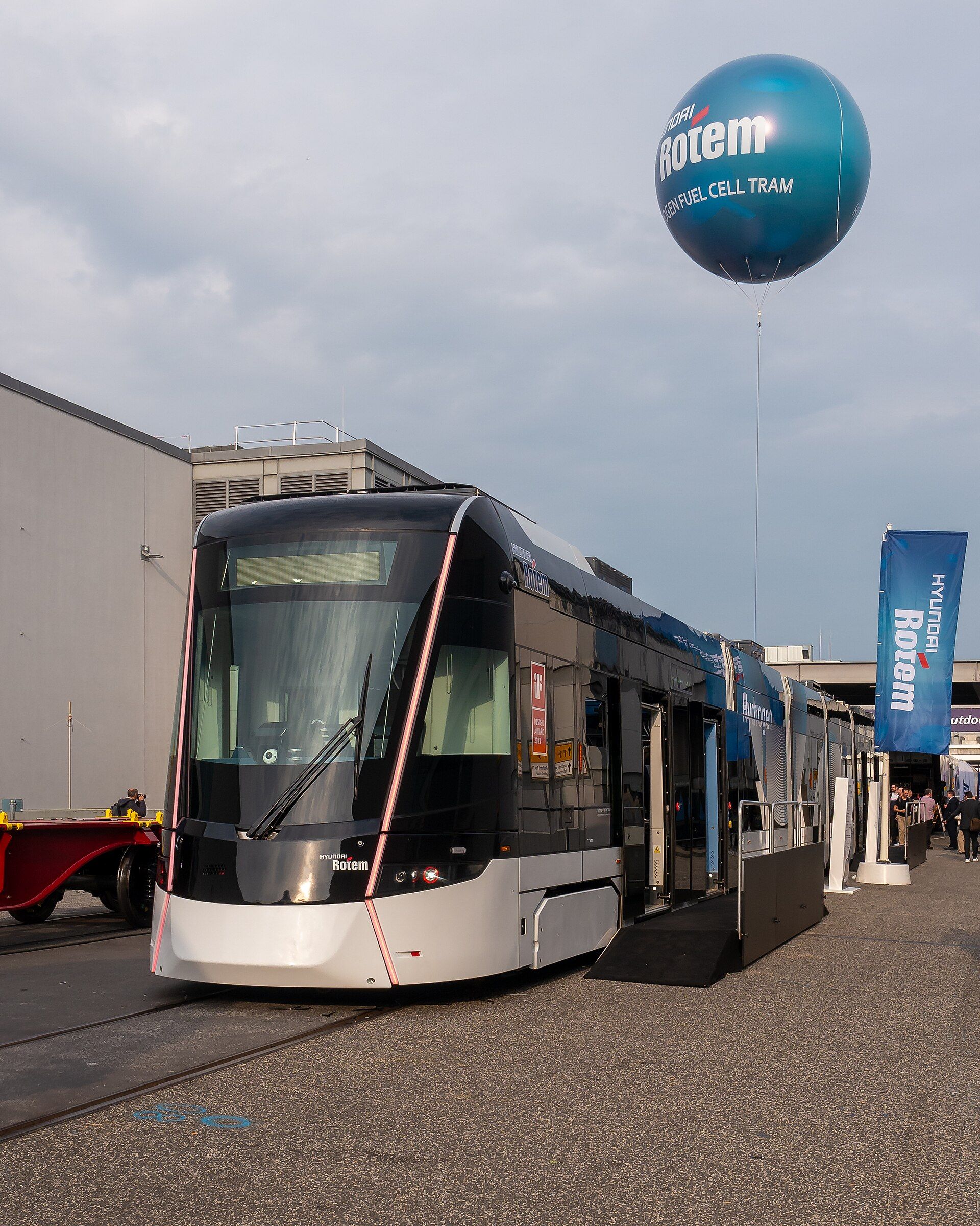 A modern tram displayed outdoors beneath InnoTrans branding at the 2024 fair
