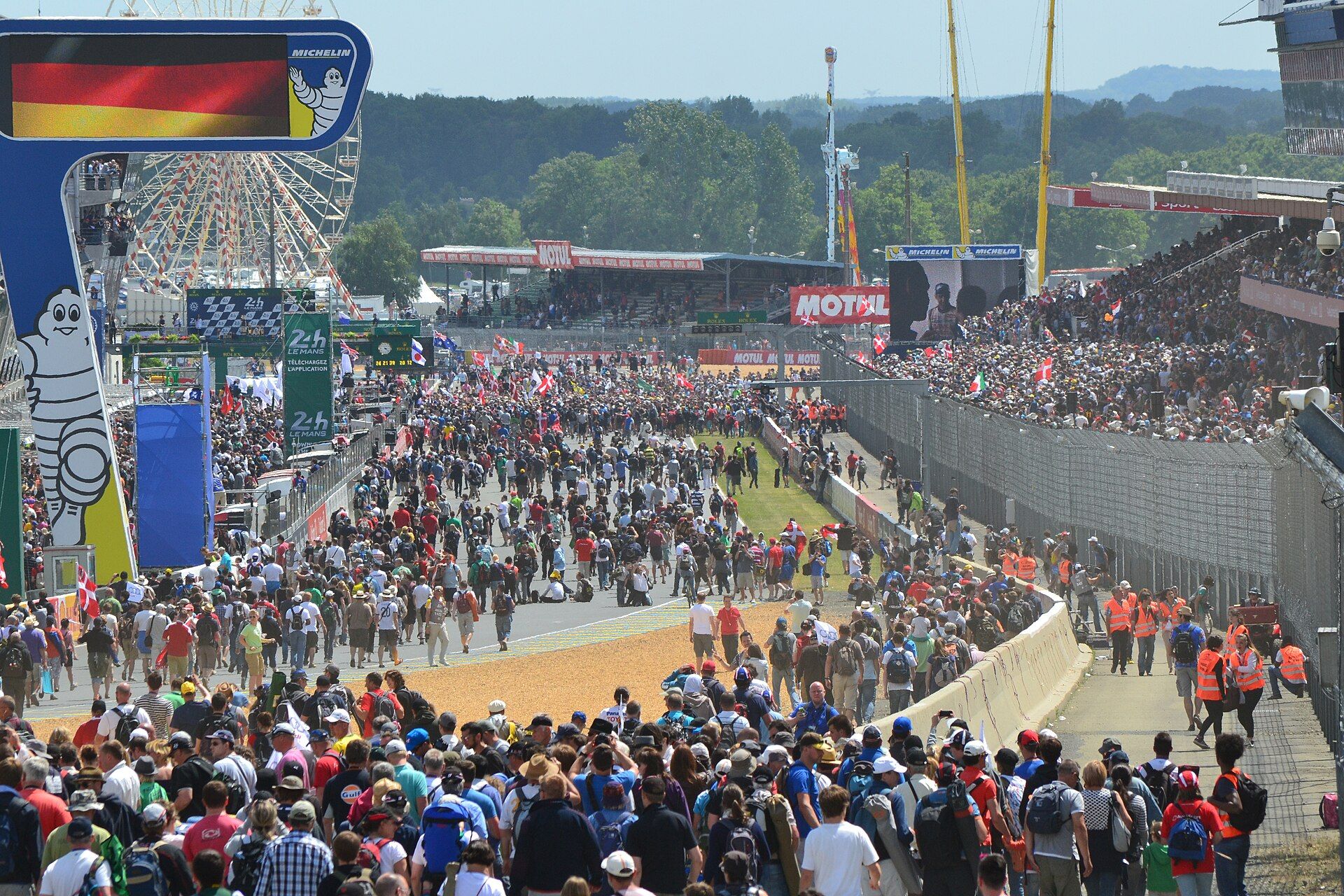 Spectators walking the Le Mans pit straight after the race