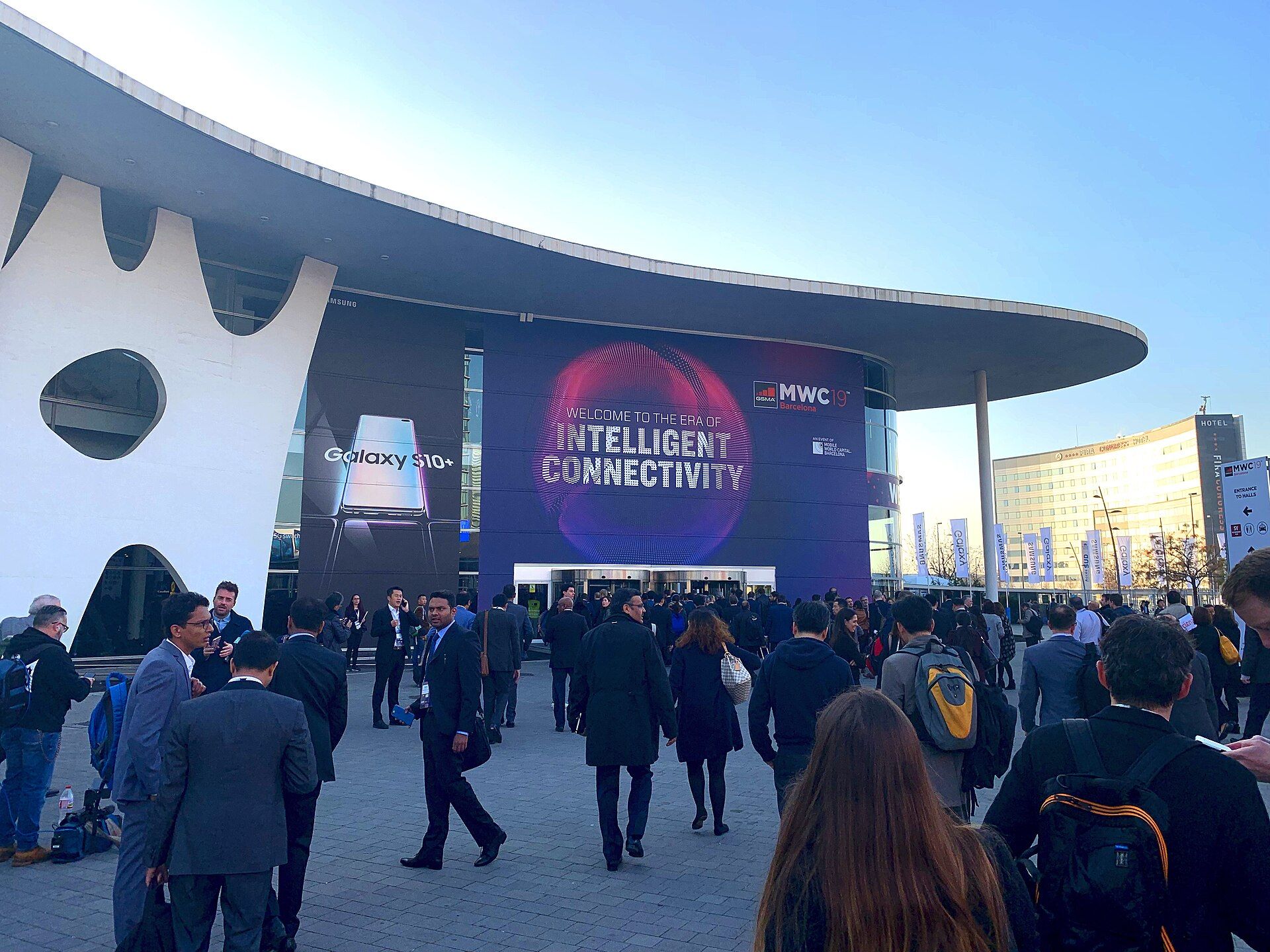 Attendees walking beneath Mobile World Congress signage in Barcelona