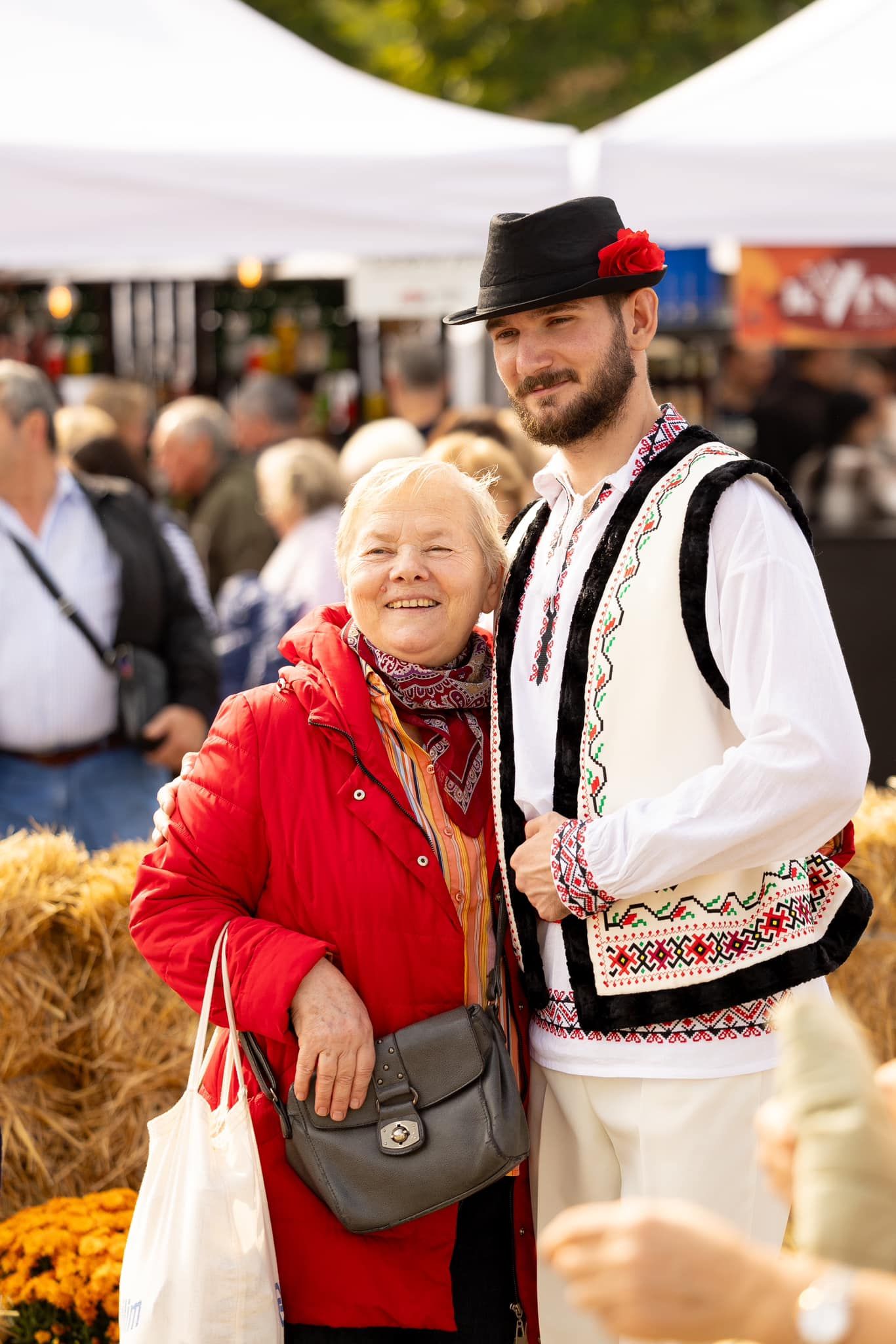 A festival visitor with a host in Moldovan folk dress