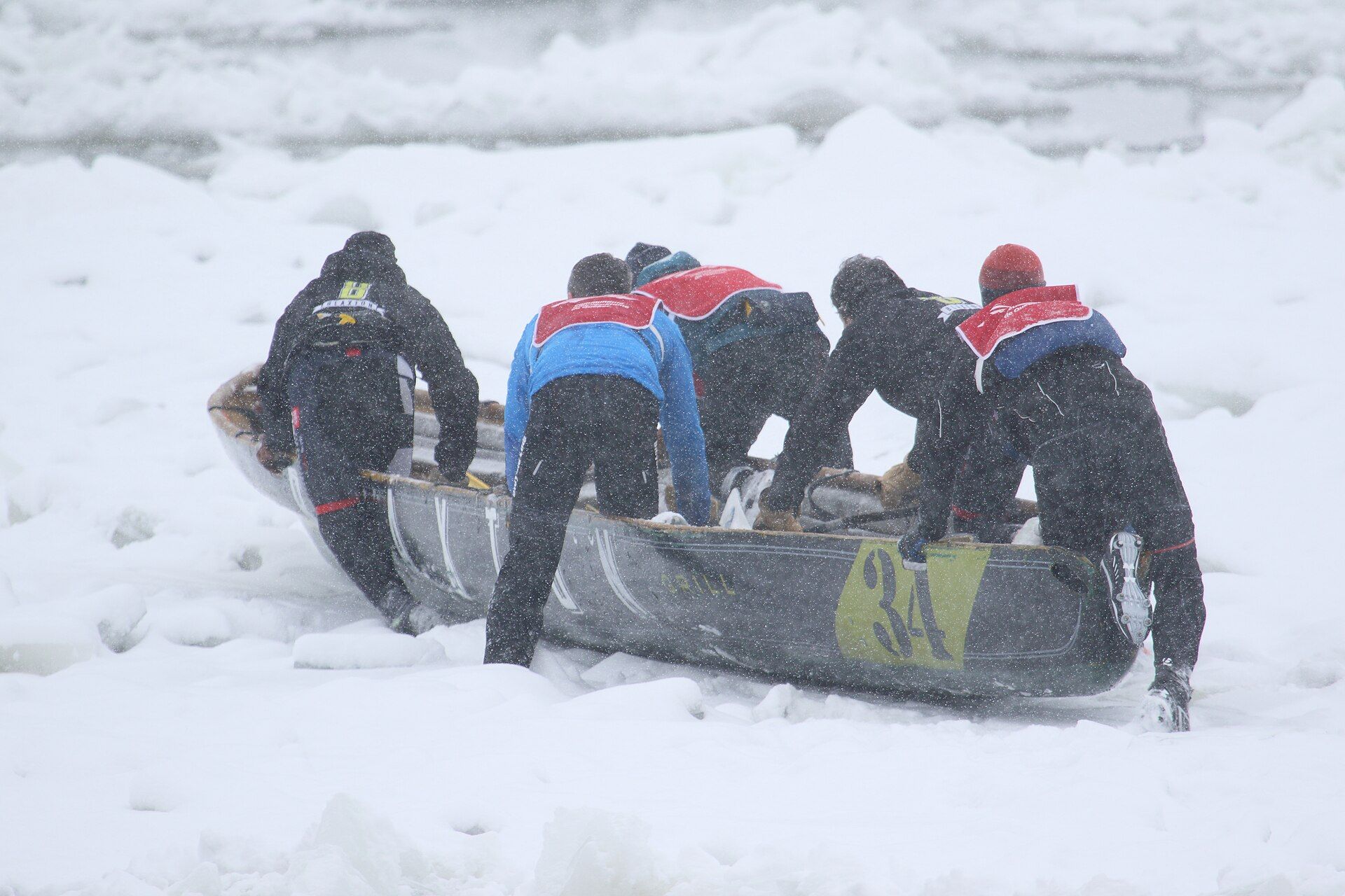 Ice-canoe racers crossing broken river ice near Québec City