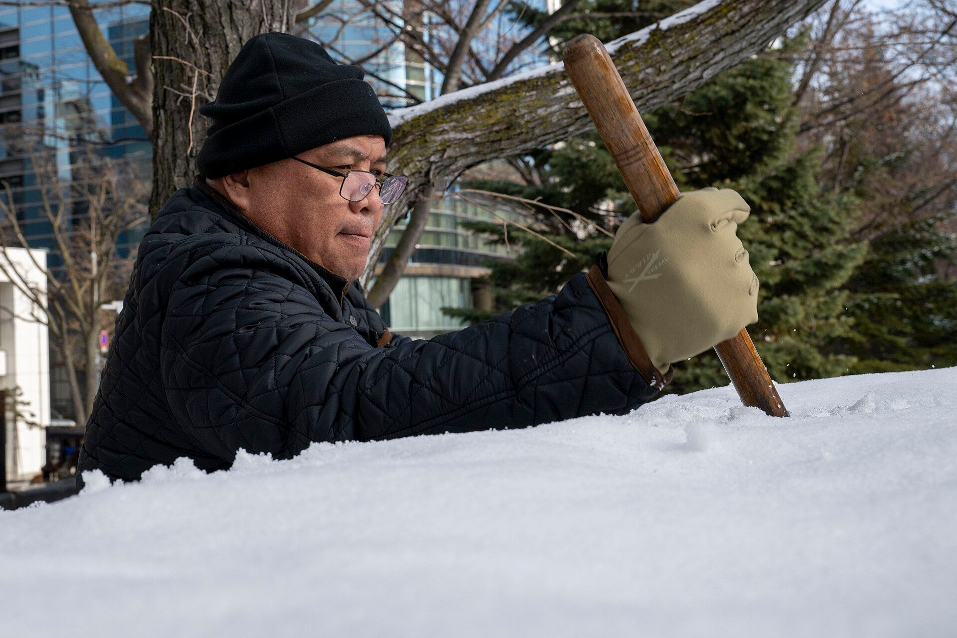 A carver shaping a snow sculpture in Sapporo