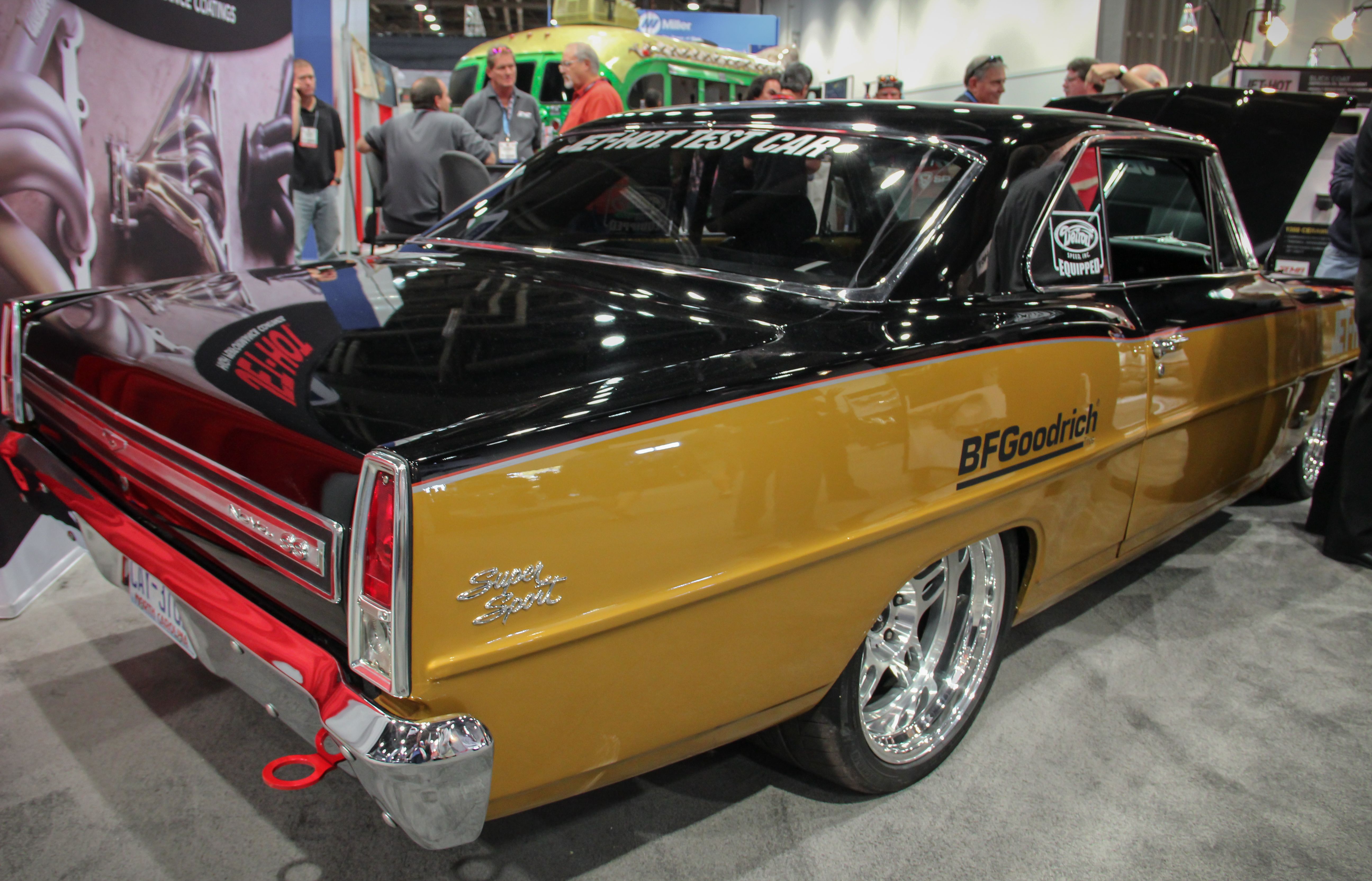 White Chevrolet Camaro with its hood open at an exhibitor tent during SEMA 2013 (prior edition, not the 2026 show)