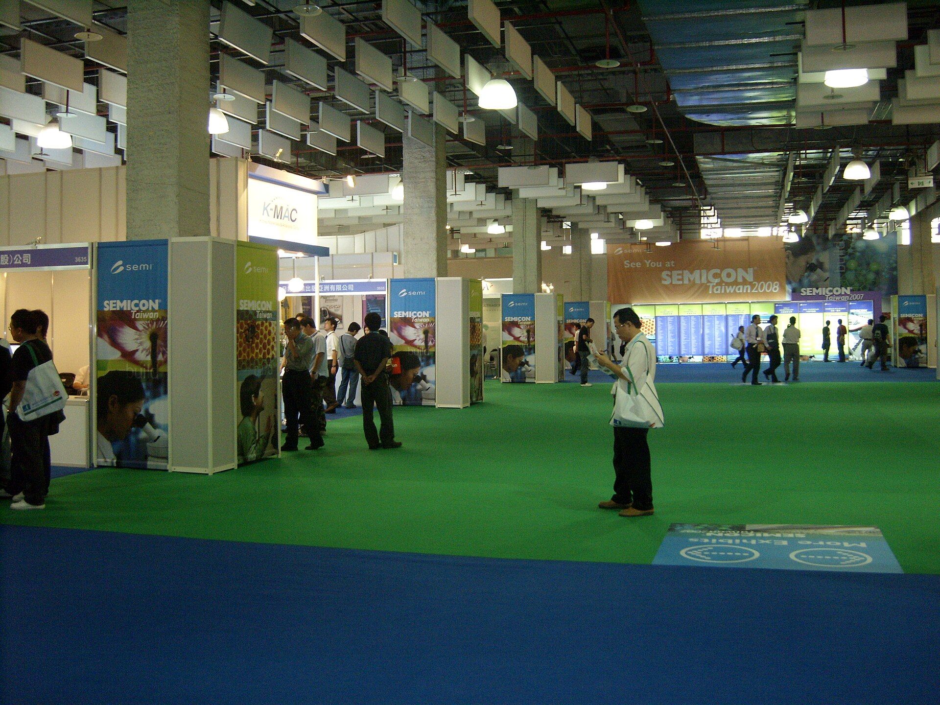 A SEMICON Taiwan exhibition hall with specialist booths and visitors