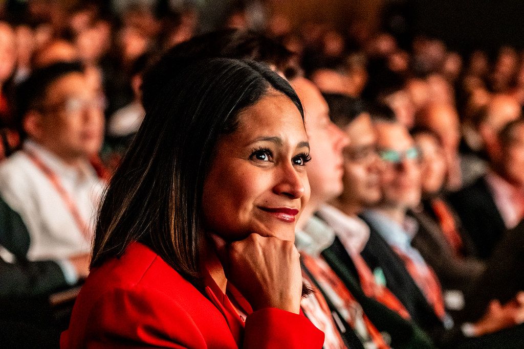A delegate listening in a full Sibos conference audience at the 2025 Frankfurt edition
