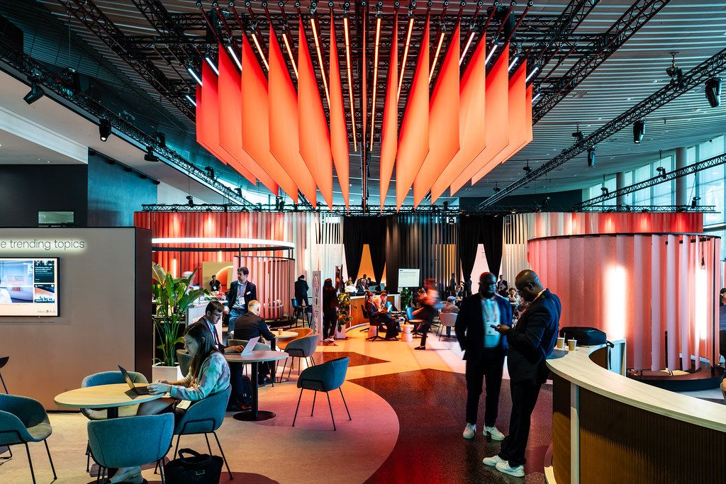 Delegates working and meeting in a Sibos networking lounge at the 2025 Frankfurt edition
